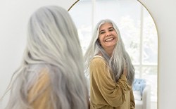 Dentures patient in Lacey looking in the mirror