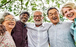 Dentures patient in Lacey smiling with friends