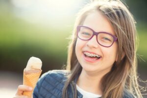 Happy preteen girl holding an ice cream cone